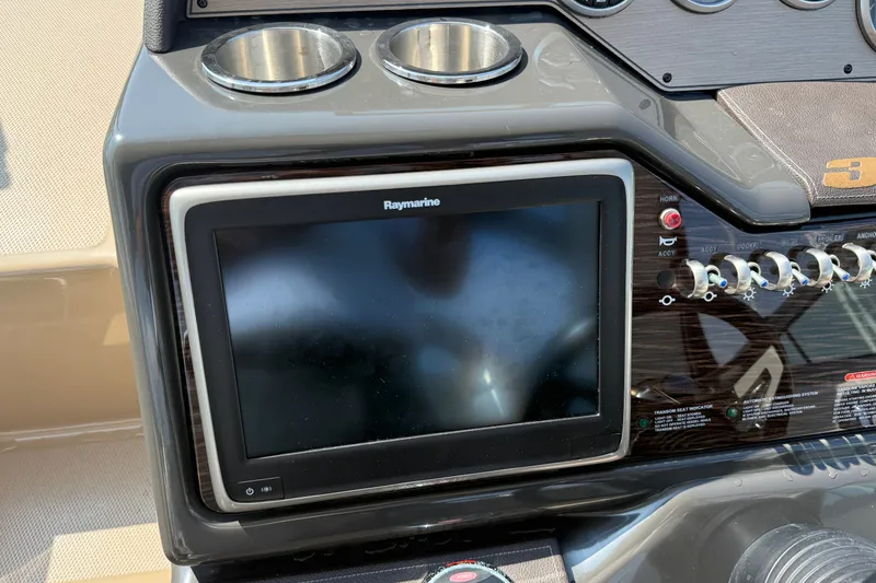 Slide: The Image of Control panel of a 2012 Sea Ray Sundancer 310 with Raymarine display and switches. - 10