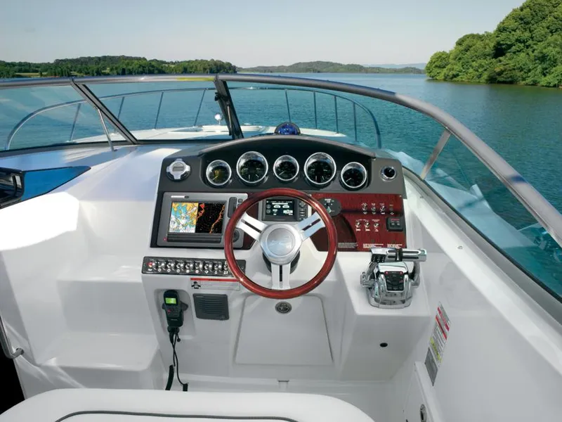 Slide: The Image of Manufacturer Provided Image: Cockpit view of 2012 Sea Ray 310 Sundancer on a serene lake. - 8