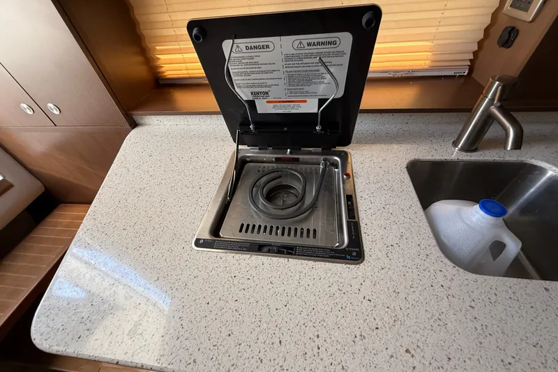 Slide: The Image of Compact kitchen area in a 2012 Sea Ray Sundancer 310 yacht with stove and sink. - 21