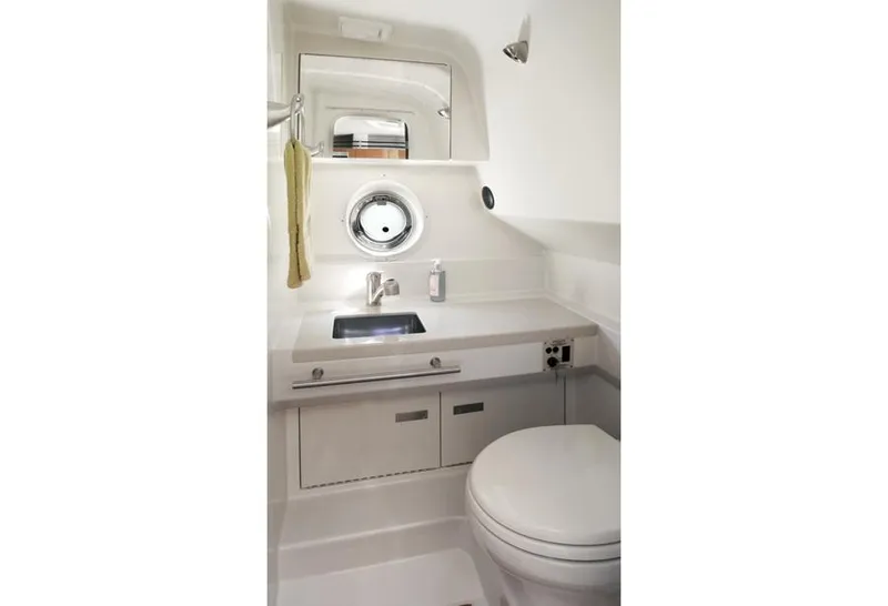 Slide: The Image of Manufacturer Provided Image: 2012 Sea Ray 310 Sundancer bathroom with sink, mirror, and toilet. - 24