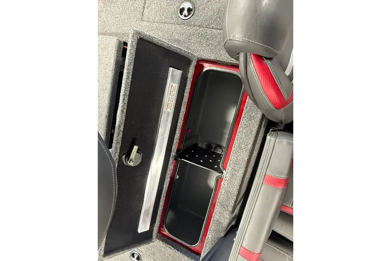 Slide: The Image of 2021 Ranger RT188 boat interior storage compartment with gray and red seating. - 17