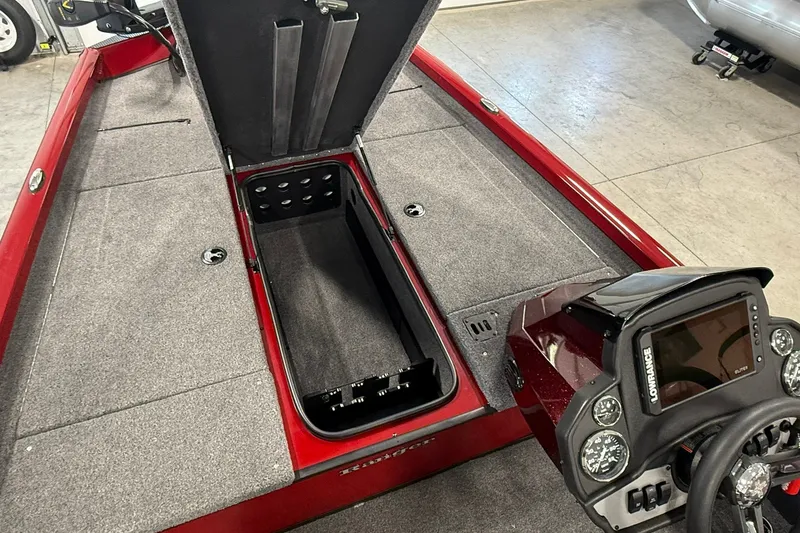 Slide: The Image of 2021 Ranger RT188 boat interior with open storage compartment and control panel. - 16