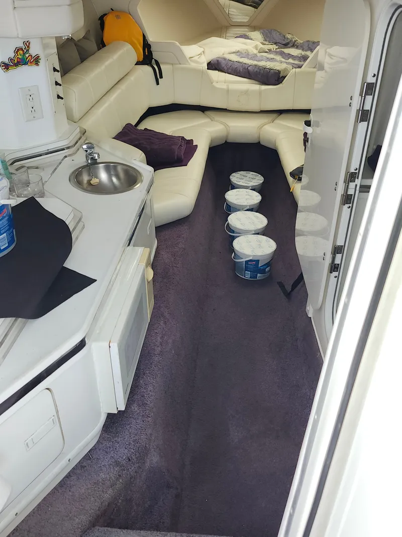 Slide: The Image of Interior of a 1999 Fountain 42 Lightning with white sofa and small kitchenette. - 1