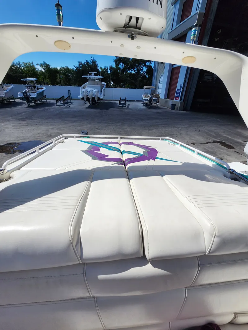 Slide: The Image of The image shows the stern of a 1999 Fountain 42 Lightning boat with cushioned seats and a colorful design. - 3