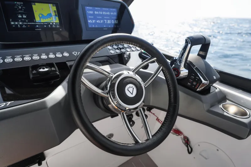 Slide: The Image of Steering wheel and controls of 2025 Valiatt 350GT boat, with ocean view. - 9
