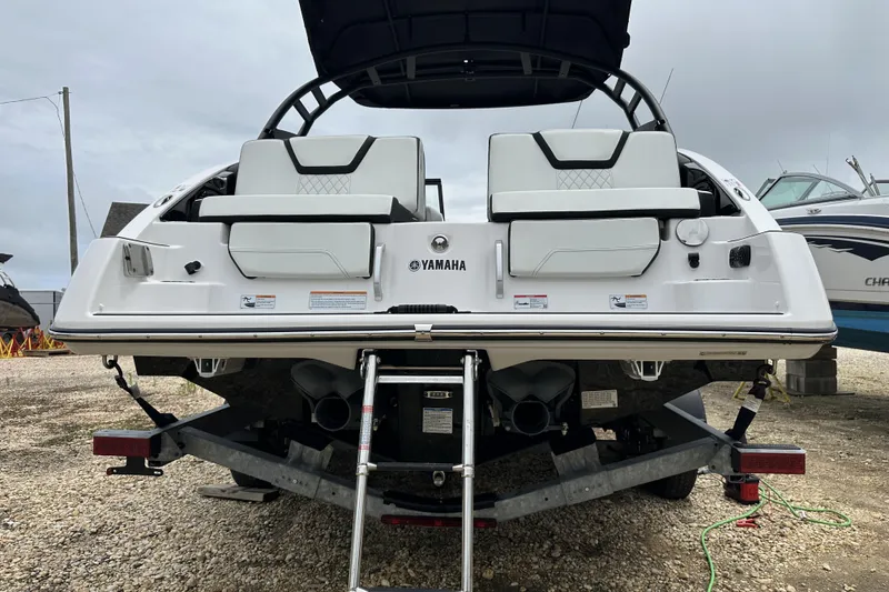 Slide: The Image of 2025 Yamaha Boats 252SD on trailer, rear view, showcasing sleek design and seating. - 6