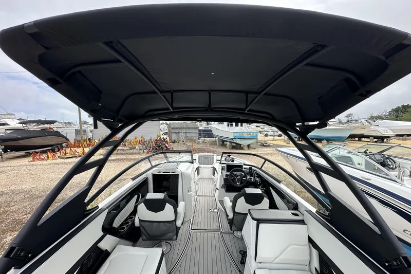 Slide: The Image of 2025 Yamaha Boats 252SD interior with sleek seating and modern design under a canopy. - 7