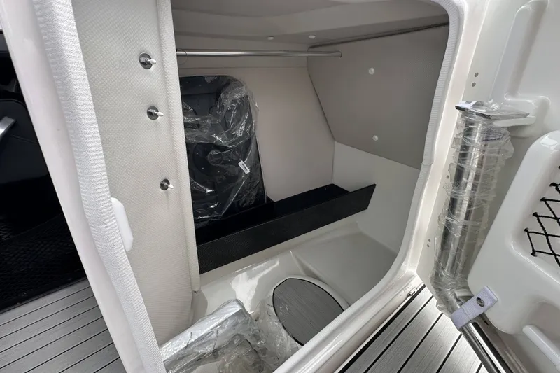 Slide: The Image of Interior storage compartment of 2025 Yamaha Boats 252SD, featuring sleek design and modern fixtures. - 13