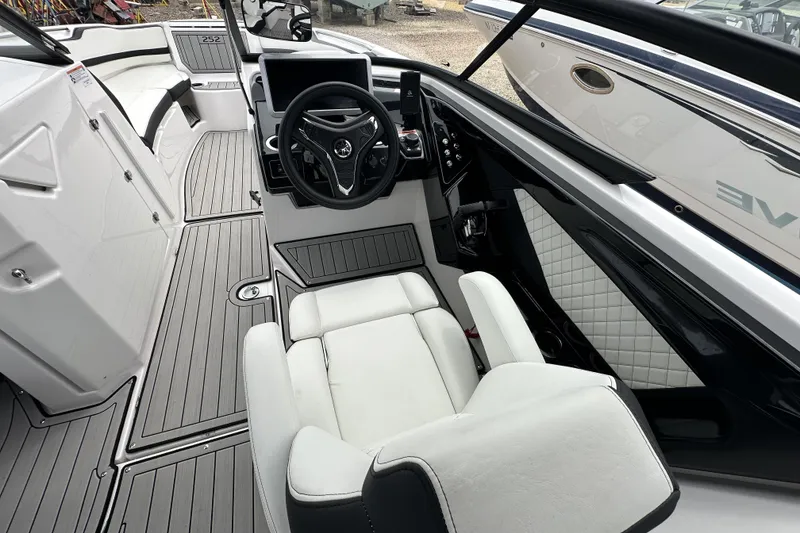Slide: The Image of 2025 Yamaha Boats 252SD interior with sleek steering wheel and modern seating design. - 8