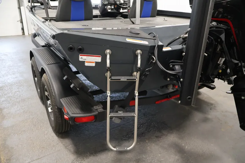 Slide: The Image of 2023 Ranger RT188P boat rear view with ladder and dual-axle trailer in a garage. - 40