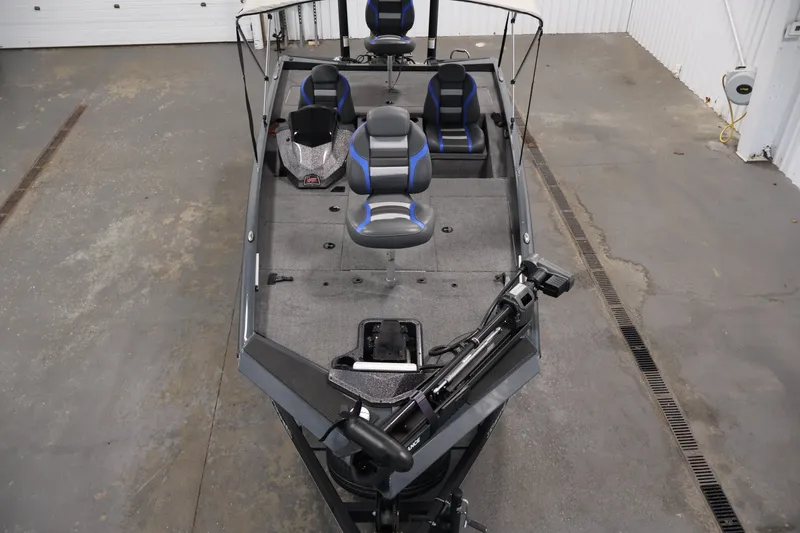 Slide: The Image of 2023 Ranger RT188P fishing boat interior with seating and equipment in a garage setting. - 9