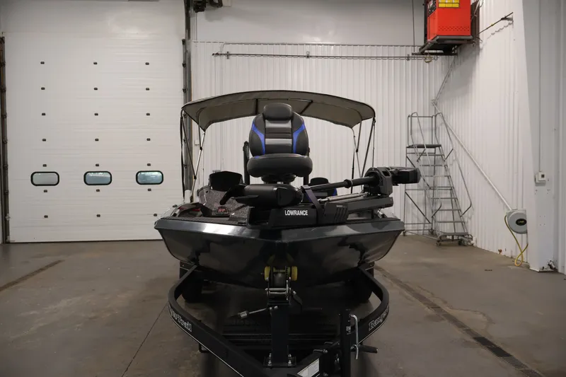 Slide: The Image of 2023 Ranger RT188P boat in a garage, featuring a Lowrance system. - 2