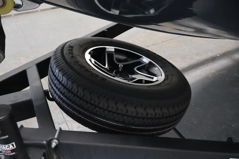 Slide: The Image of 2023 Ranger RT188P trailer tire and wheel detail in a garage setting. - 47