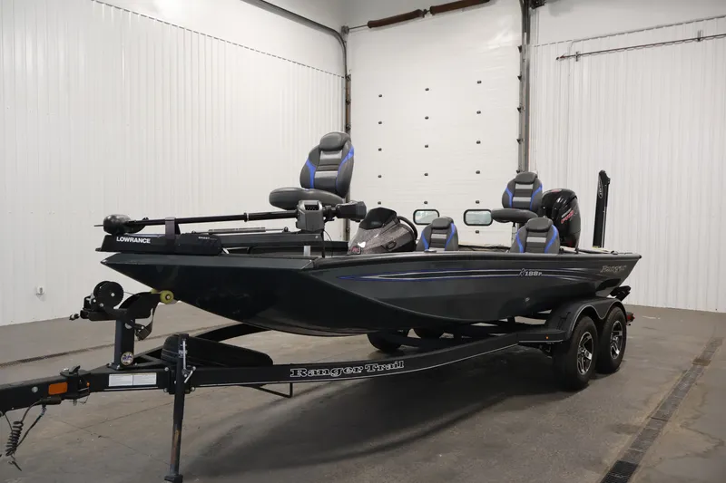 Slide: The Image of 2023 Ranger RT188P fishing boat in a garage, featuring sleek design and modern equipment. - 50