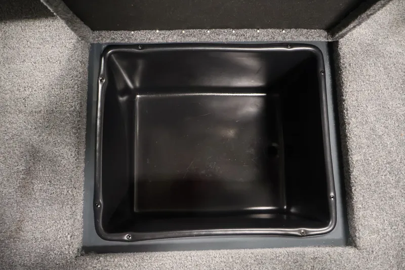 Slide: The Image of Storage compartment in 2023 Ranger RT188P boat, featuring a black interior and gray carpeted edges. - 39