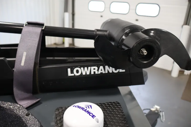 Slide: The Image of 2023 Ranger RT188P boat with Lowrance trolling motor and equipment in a garage setting. - 12
