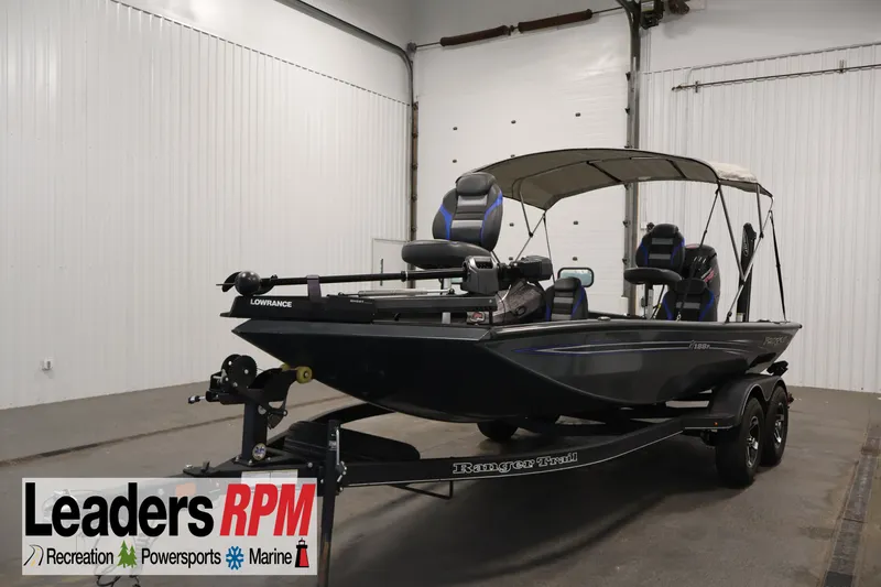 The Image of 2023 Ranger RT188P fishing boat in showroom, featuring Lowrance equipment and canopy. - 1