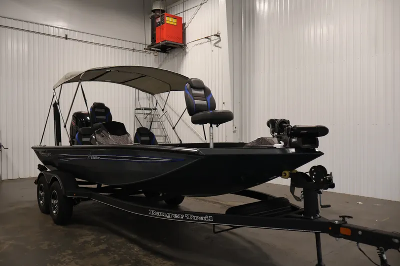 Slide: The Image of 2023 Ranger RT188P fishing boat with canopy in a garage setting. - 3