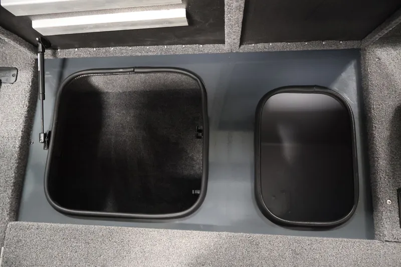 Slide: The Image of 2023 Ranger RT188P boat storage compartments with open lids, showcasing interior space. - 21