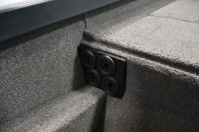 Slide: The Image of 2023 Ranger RT188P boat interior with carpeted storage compartment and rod holders. - 24
