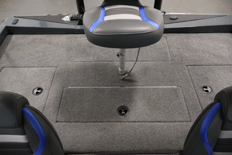 Slide: The Image of 2023 Ranger RT188P boat interior with gray carpet and blue-accented seats. - 35