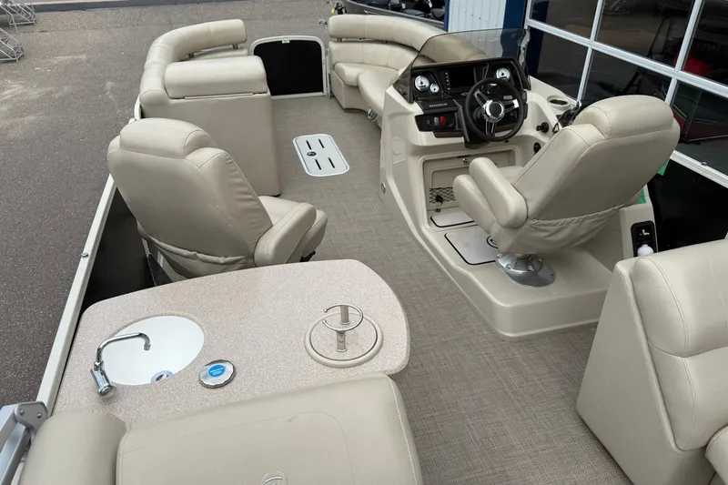 Slide: The Image of 2016 Premier 270 Intrigue RF boat interior with beige seating and steering console. - 22