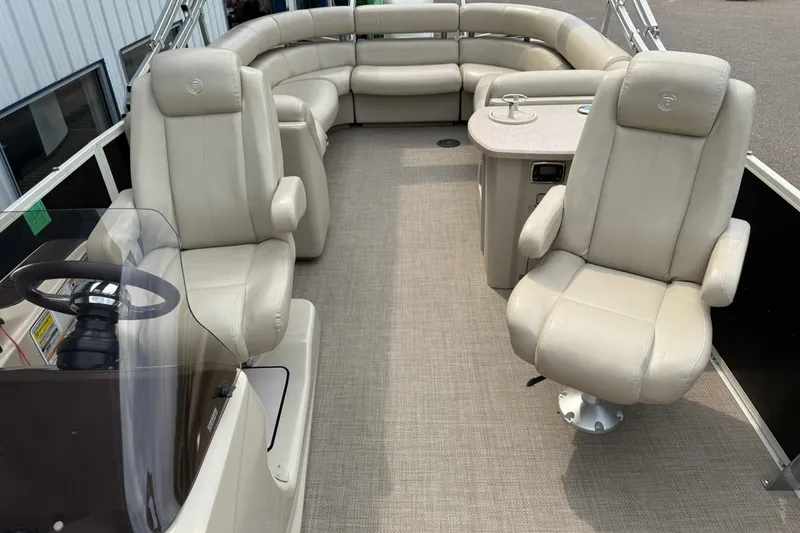 Slide: The Image of Interior of a 2016 Premier 270 Intrigue RF pontoon boat with beige seating. - 10