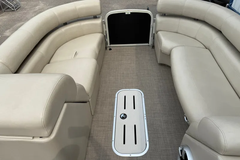 Slide: The Image of Interior of 2016 Premier 270 Intrigue RF pontoon boat with beige seating and carpeted floor. - 11