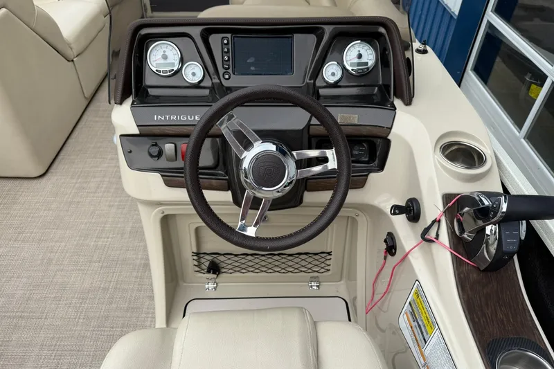 Slide: The Image of 2016 Premier 270 Intrigue RF boat dashboard with steering wheel and controls. - 17