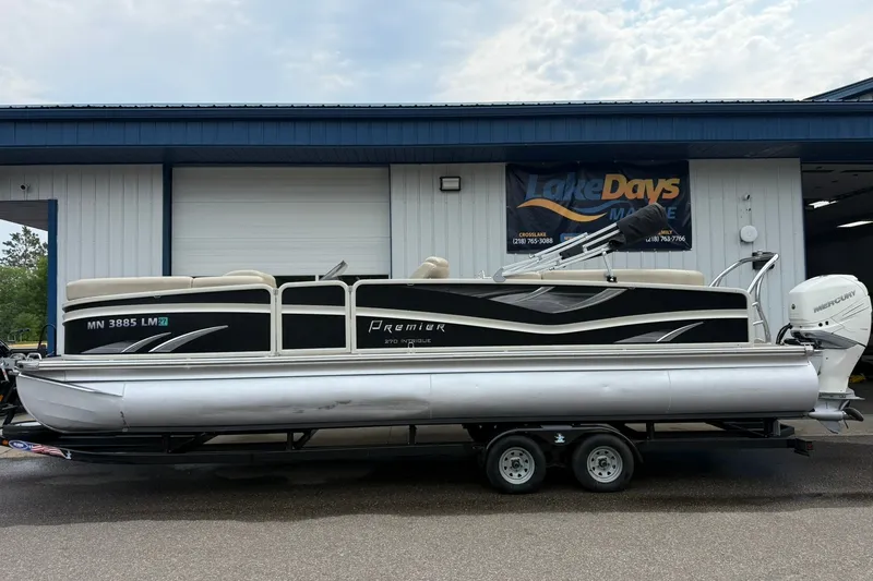 The Image of 2016 Premier 270 Intrigue RF pontoon boat on trailer outside Lake Days Marine. - 1