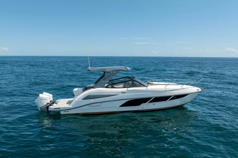 Slide: The Image of 2025 Valiatt 350GT luxury boat cruising on open sea under clear blue sky. - 2