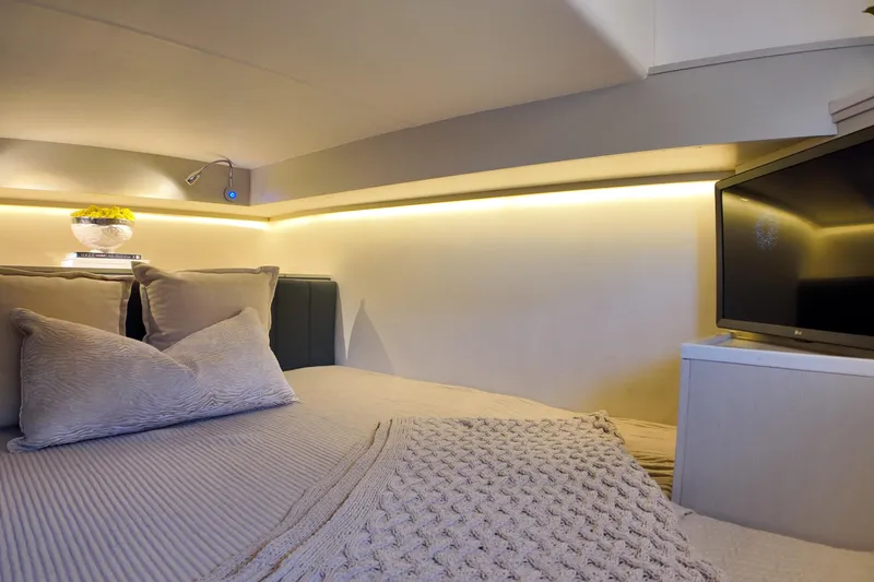 Slide: The Image of Luxurious interior of 2025 Valiatt 350GT with cozy bedding and modern TV setup. - 14