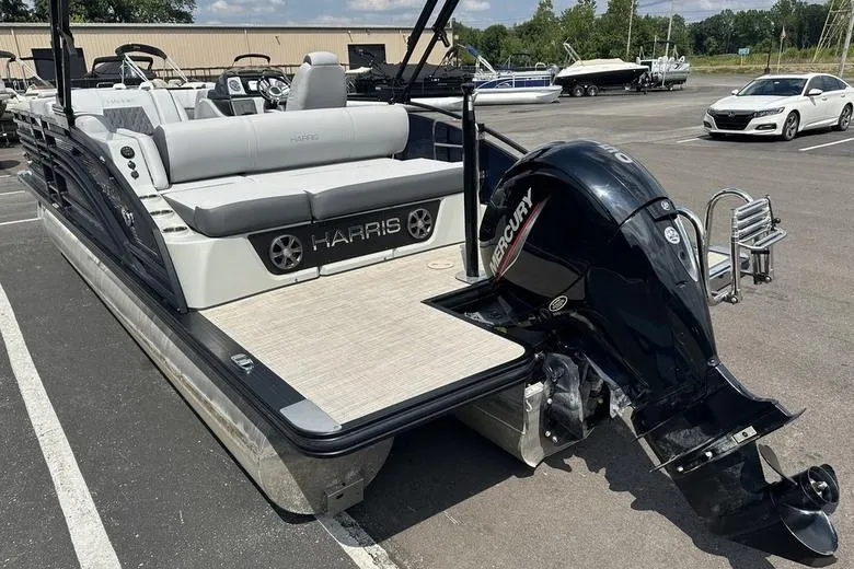 Slide: The Image of 2020 Harris Solstice 230 SL pontoon boat with Mercury outboard motor in a parking lot. - 10