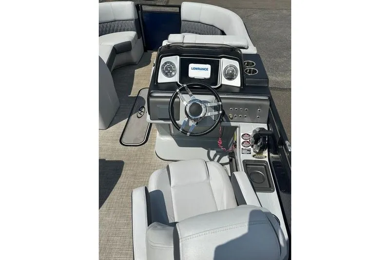 Slide: The Image of 2020 Harris Solstice 230 SL boat interior with steering wheel and Lowrance display. - 8