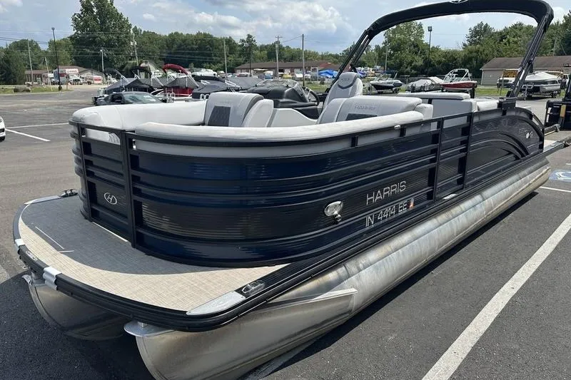 Slide: The Image of 2020 Harris Solstice 230 SL pontoon boat in a parking lot, showcasing sleek design. - 7