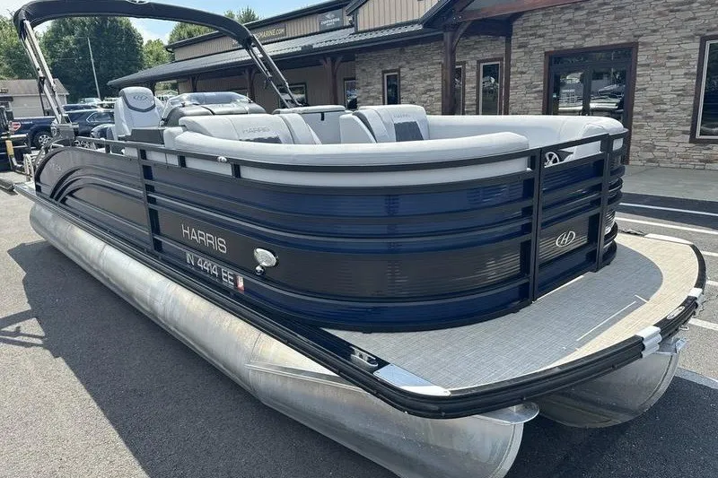 Slide: The Image of 2020 Harris Solstice 230 SL pontoon boat with sleek design, parked outdoors. - 6