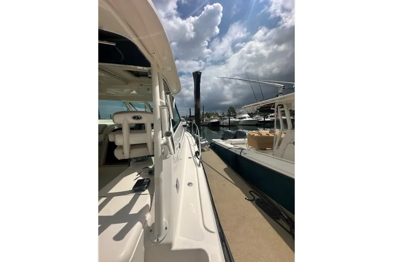 Slide: The Image of 2013 Pursuit OS 345 Offshore boat docked under cloudy skies. - 32
