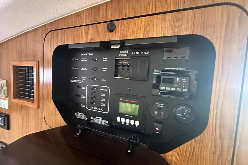 Slide: The Image of Control panel of a 2013 Pursuit OS 345 Offshore boat, featuring various switches and gauges. - 21