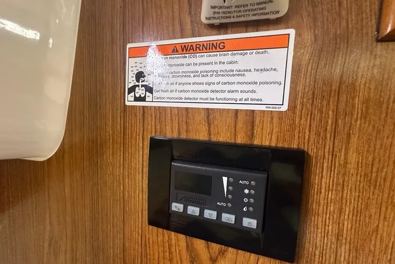 Slide: The Image of Warning label and control panel inside 2013 Pursuit OS 345 Offshore boat cabin. - 23