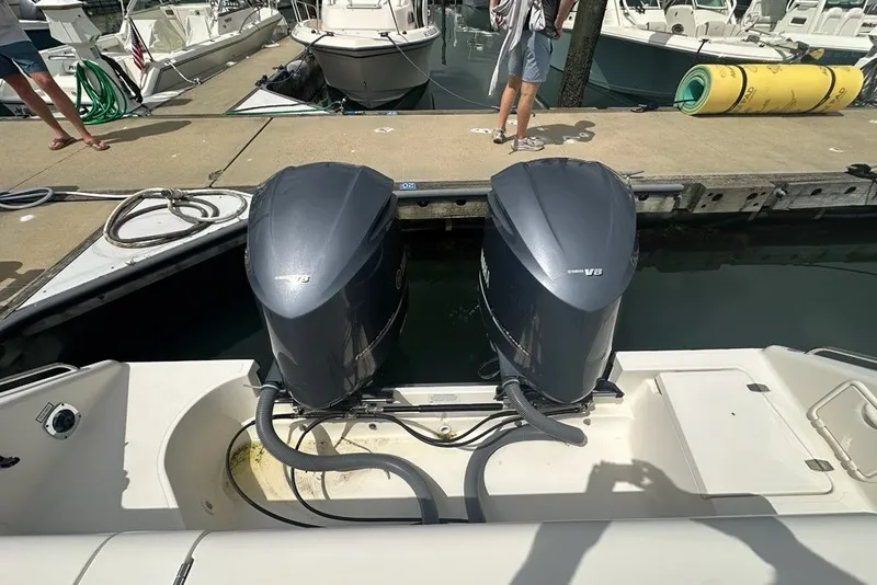 Slide: The Image of 2013 Pursuit OS 345 Offshore boat with twin Yamaha V8 outboard engines at dock. - 37