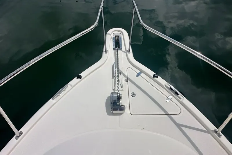 Slide: The Image of Bow of 2013 Pursuit OS 345 Offshore boat with anchor chain and railing. - 34