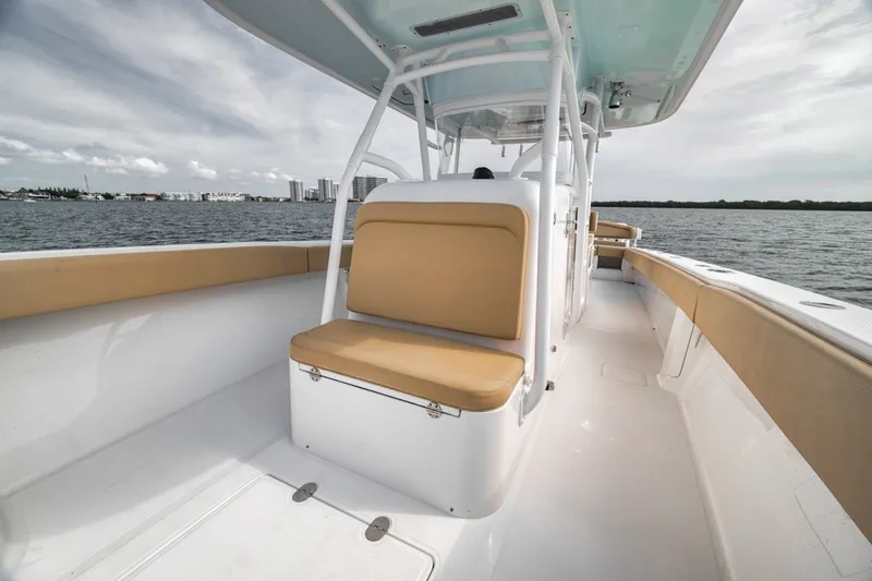 Slide: The Image of 2020 Bahama 41 boat with tan seating, cruising on calm waters under a cloudy sky. - 23