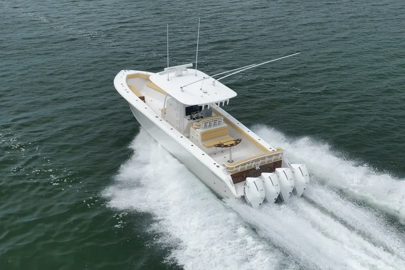 Slide: The Image of 2020 Bahama 41 boat cruising on open water with four engines. - 46