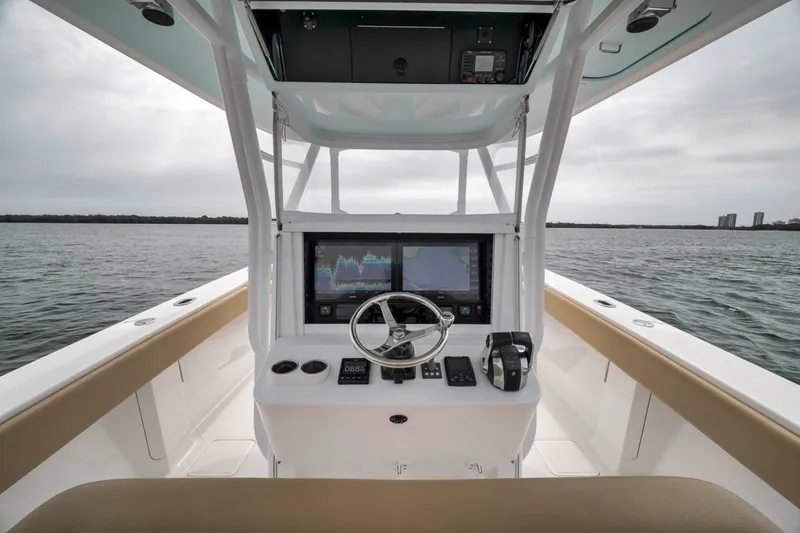 Slide: The Image of Cockpit view of 2020 Bahama 41 boat with navigation screens and steering wheel. - 29