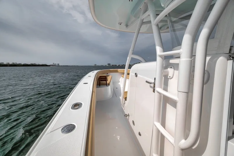 Slide: The Image of Bahama 41 boat, 2020 model, sleek white deck, ocean view, overcast sky. - 31
