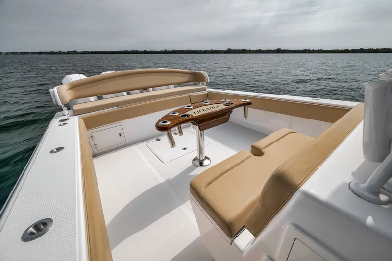 Slide: The Image of Luxurious 2020 Bahama 41 boat interior with tan seating and wooden table on open water. - 36