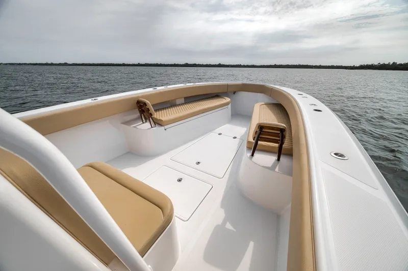 Slide: The Image of 2020 Bahama 41 boat interior with tan seating on calm water. - 25