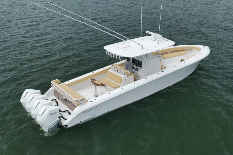 Slide: The Image of 2020 Bahama 41 boat with triple Mercury engines on open water. - 13