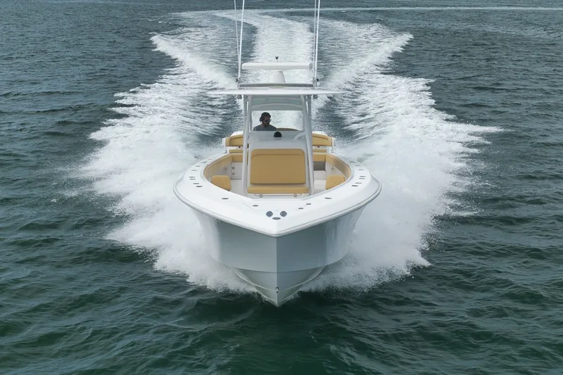 Slide: The Image of 2020 Bahama 41 boat cruising on open water, creating a dynamic wake. - 14