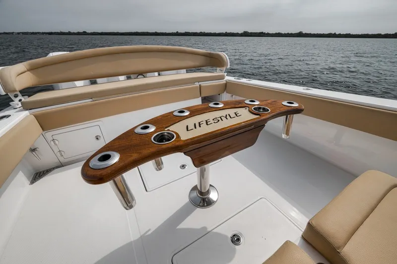 Slide: The Image of 2020 Bahama 41 boat interior with custom wooden table labeled "Lifestyle" on open water. - 37